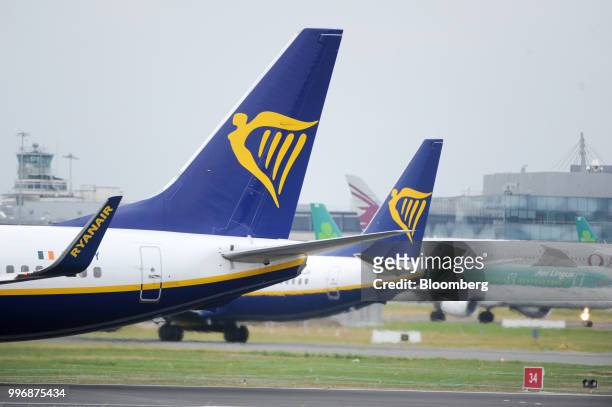 Passenger aircrafts operated by Ryanair Holdings Plc taxi on the tarmac at Dublin Airport in Dublin, Ireland, on Thursday, July 12, 2018. Ryanair...