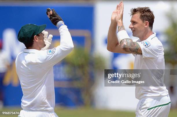 South African fast bowler Dale Syten giving high fives to wicketkeeper Quinton de kock after dismissing Kusal Mendis during day 1 of the 1st Test...