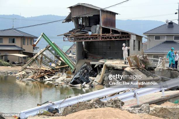 Kurashiki City officials investigate the damage after flood on July 11, 2018 in Kurashiki, Okayama, Japan. The death toll from the torrential rain in...