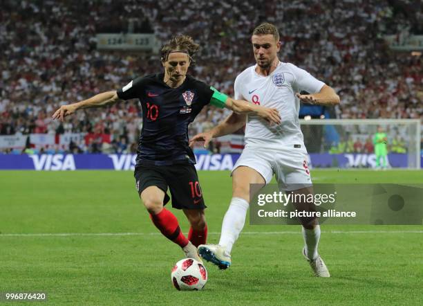 July 2018, Russia, Moscow: Soccer, FIFA World Cup 2018, final round, semi-finals: Croatia vs England at Luzhniki Stadium: Croatia's Luka Modric and...