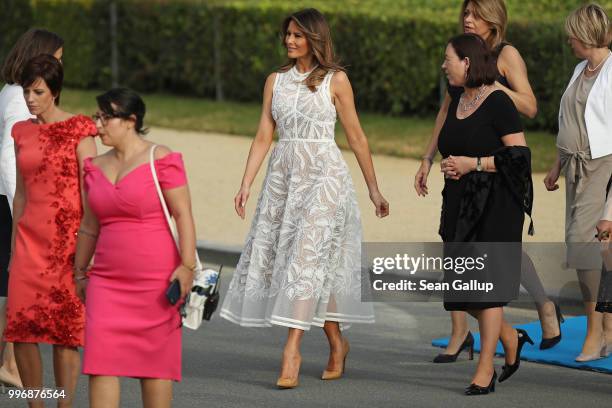 First Lady Melania Trump and other spouses of heads of state and governments attend the evening reception and dinner at the 2018 NATO Summit on July...