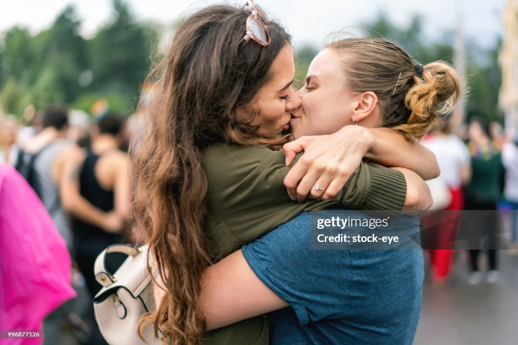 Young adult female couple at pride parade