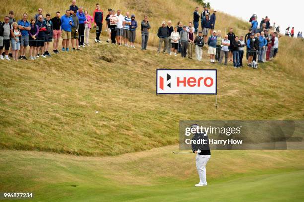 Kiradech Aphibarnrat of Thailand takes a chip shot on hole one during day one of the Aberdeen Standard Investments Scottish Open at Gullane Golf...