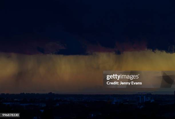 The sun sets over the Sydney skyline on July 12, 2018 in Sydney, Australia. The dramatic skies were caused by showers and local thunder moving across...