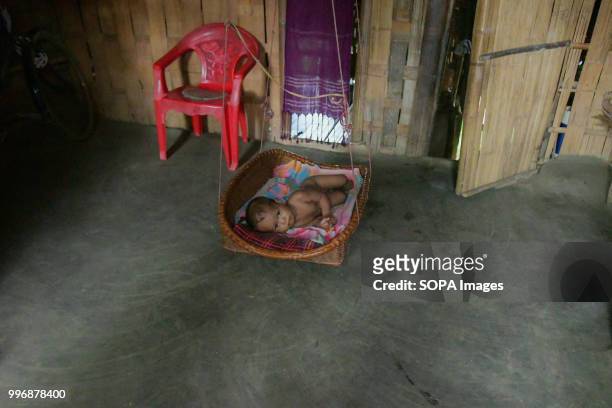Reyang baby seen sleeping on a mattress made from bamboo, in Kanchanpur refugee camp, 200 km far from Agartala. 35,000 people of Reang also called...