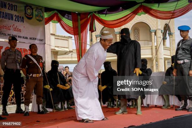 Aceh man seen in pain during the flogging. 18 people were convicted by the Meulaboh Sharia Court of different crimes and flogged between 5 times to...