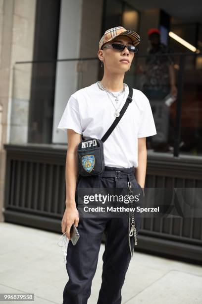 Fuji is seen on the street during Men's New York Fashion Week wearing H&M with Burberry hat on July 11, 2018 in New York City.