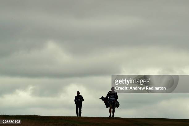Chris Hanson of England and his caddy walk on hole ten during day one of the Aberdeen Standard Investments Scottish Open at Gullane Golf Course on...