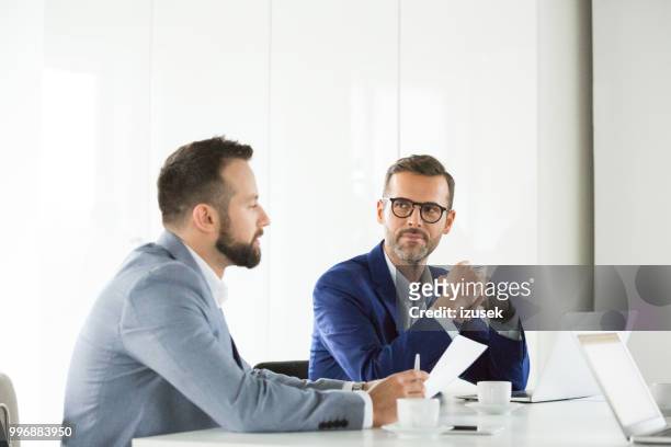 business team brainstorming in meeting - izusek stock pictures, royalty-free photos & images