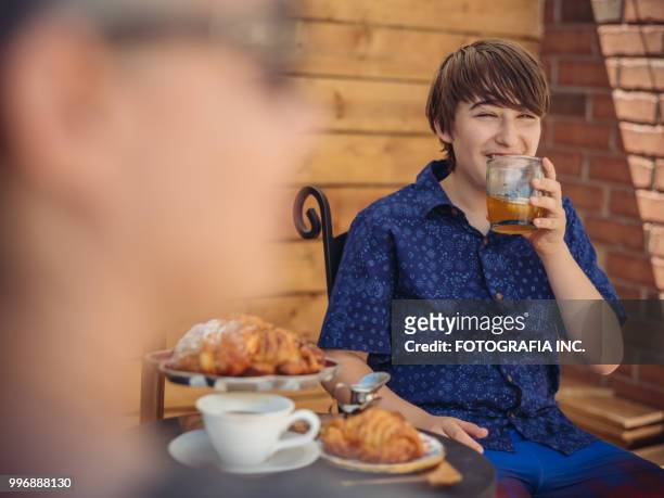 patio time with moter and son - fotografia stock pictures, royalty-free photos & images