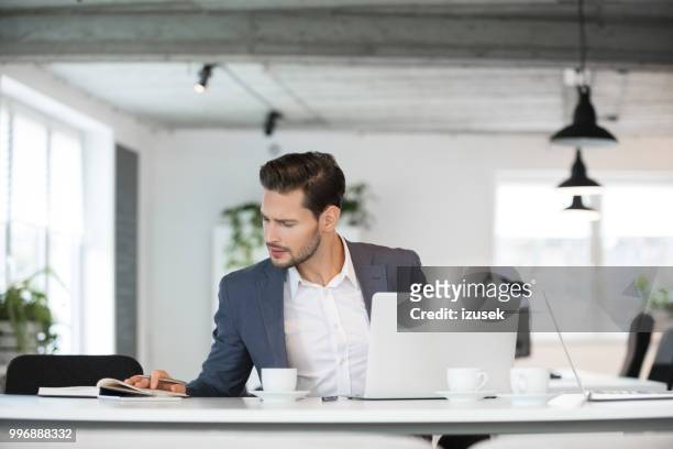 young businessman at work - izusek stock pictures, royalty-free photos & images
