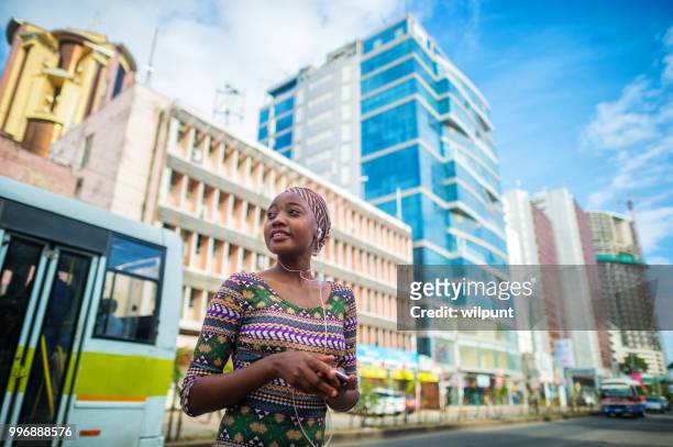 young confident african woman in city centre - city bus stock pictures, royalty-free photos & images