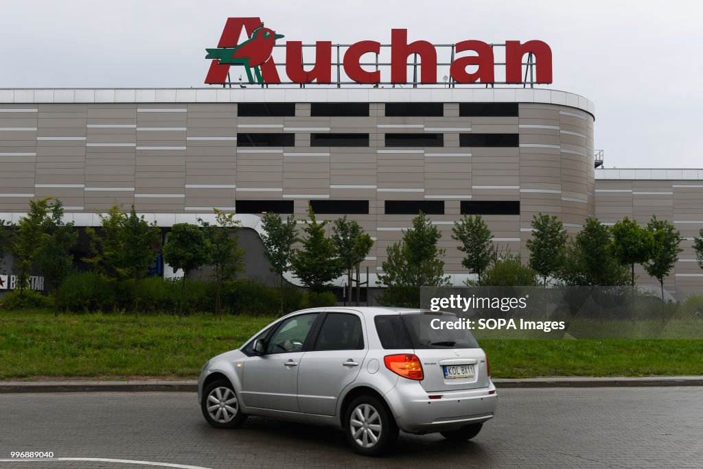 A car drives in front of French supermarket Auchan in Krakow...