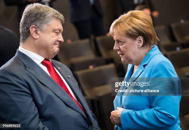 July 2018, Brussels, Belgium: Petro Poroshenko, President of Ukraine, and German Chancellor Angela Merkel are talking at the beginning of the working...