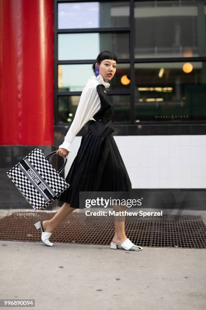 Michelle Song is seen on the street during Men's New York Fashion Week wearing Balenciaga skirt and top with Dior on July 11, 2018 in New York City.