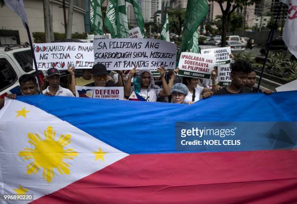 Activists participate on a protest in front of the Chinese Consular office in Manila on July 12 to mark the second anniversary of a UN-backed...