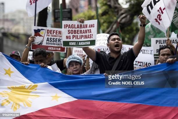 Activists participate on a protest in front of the Chinese Consular office in Manila on July 12 to mark the second anniversary of a UN-backed...