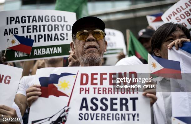 Activists participate on a protest in front of the Chinese Consular office in Manila on July 12 to mark the second anniversary of a UN-backed...