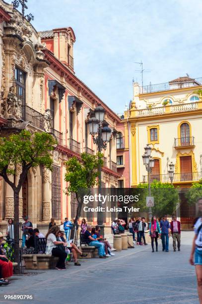 Pedestrians on Calle Don Remondo in Seville, Spain.