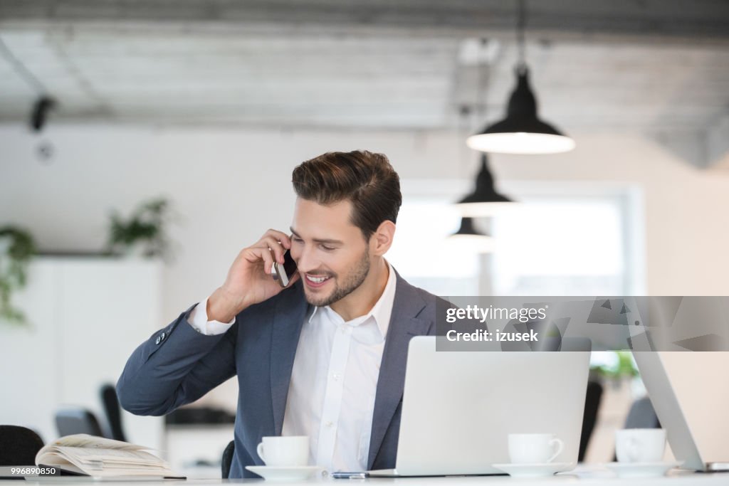Smiling young businessman working in office