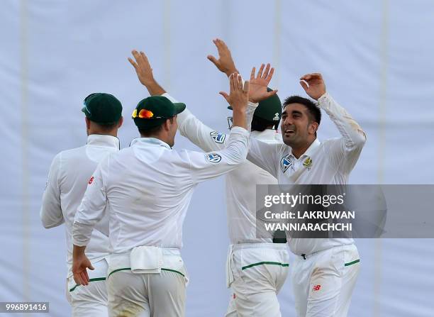 South Africa's Tabraiz Shamsi celebrates with teammates after dismissing Sri Lanka's batsman Niroshan Dickwella during the first day of the opening...