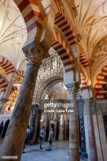 Tourists inside the Cordoba Mezquita, a cathedral originally built as a mosque which boasts some of the finest examples of Islamic architecture in...