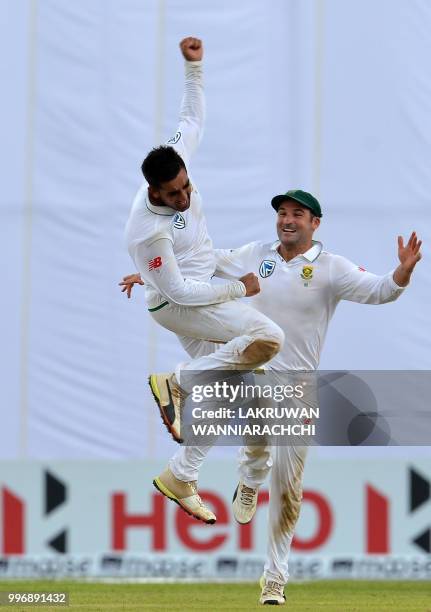 South Africa's Tabraiz Shamsi celebrates with teammate Dean Elgar after dismissing Sri Lanka's batsman Niroshan Dickwella during the first day of the...