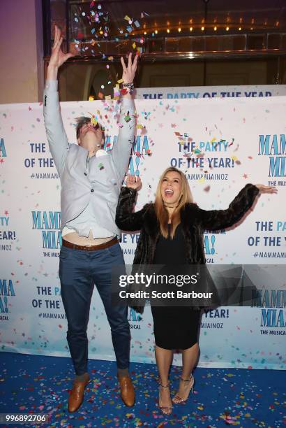 Carly Bowyer and Troy Delmege throw confetti in the air as they attend the opening night of Mamma Mia! The Musical at Princess Theatre on July 12,...