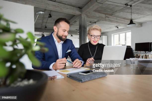 senior business management team working together - izusek stock pictures, royalty-free photos & images