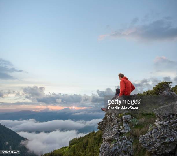 man admiring the sunset in the mountains - rgb stock pictures, royalty-free photos & images