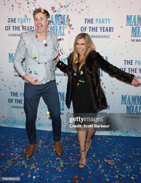 Carly Bowyer and Troy Delmege throw confetti in the air as they attend the opening night of Mamma Mia! The Musical at Princess Theatre on July 12,...