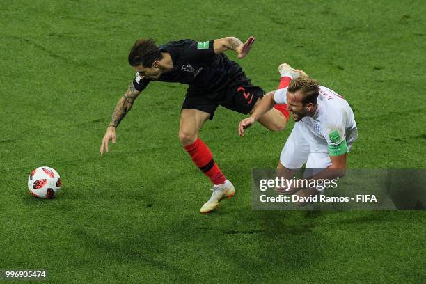 Harry Kane of England is brought down by Lovre Kalinic of Croatia during the 2018 FIFA World Cup Russia Semi Final match between England and Croatia...