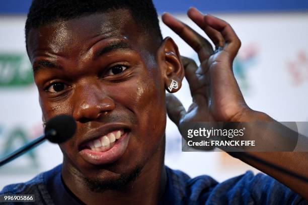 France's midfielder Paul Pogba gestures during a press conference at the press centre in Istra, west of Moscow, on July 12 ahead of their Russia 2018...