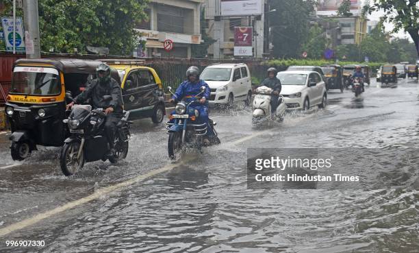 Vehicles wade through waterlogged street at SV Road, Santacruz, on July 11, 2018 in Mumbai, India. Heavy rains made a comeback in Mumbai causing...