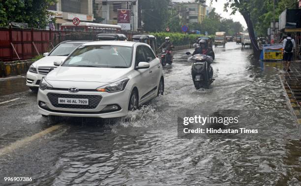 Vehicles wade through waterlogged street at SV Road, Santacruz, on July 11, 2018 in Mumbai, India. Heavy rains made a comeback in Mumbai causing...