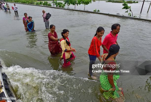 People wades through a water logged street at Ambadi Road Vasai East, on July 11, 2018 in Mumbai, India. Heavy rains made a comeback in Mumbai...