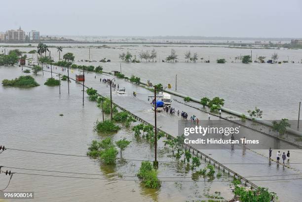 People wades through a water logged street at Ambadi Road Vasai East, on July 11, 2018 in Mumbai, India. Heavy rains made a comeback in Mumbai...