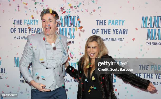 Carly Bowyer and Troy Delmege throw confetti in the air as they attend the opening night of Mamma Mia! The Musical at Princess Theatre on July 12,...