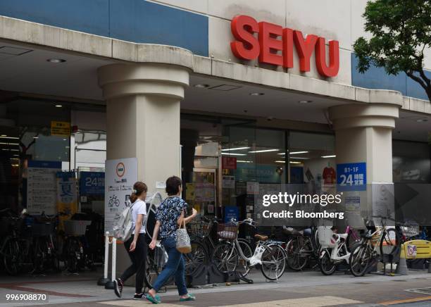 Pedestrians walk past a Seiyu store, operated by Seiyu GK, in Tokyo, Japan, on Thursday, July 12, 2018. Walmart Inc. Plans to sell its Japan...