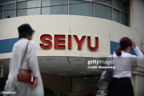 Pedestrians walk past a Seiyu store, operated by Seiyu GK, in Tokyo, Japan, on Thursday, July 12, 2018. Walmart Inc. Plans to sell its Japan...