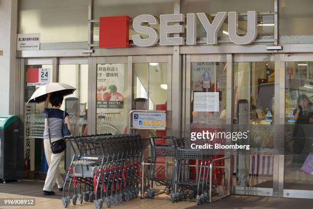 Customer walks toward a Seiyu GK supermarket in Tokyo, Japan on Thursday, July 12, 2018. Photographer: Akio Kon/Bloomberg via Getty Images
