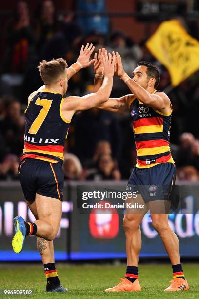 Jordan Gallucci of the Crows and Eddie Betts of the Crows celebrates after kicking a goal during the round 17 AFL match between the Adelaide Crows...