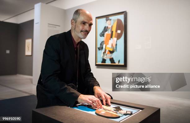 Reiner Delgado, social referent of the German Association for the Blind and Visually Impaired , touches a model of the painting 'Synthetic Musician'...