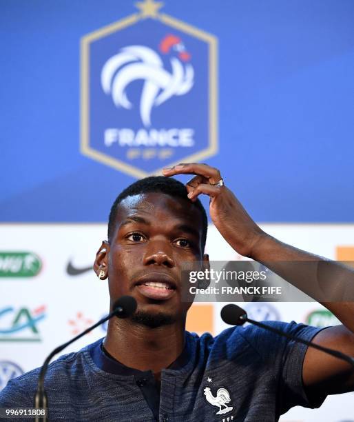 France's midfielder Paul Pogba gestures during a press conference at the press centre in Istra, west of Moscow, on July 12 ahead of their Russia 2018...