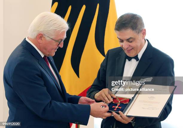 German President Frank-Walter Steinmeier presents the Order of Merit of the Federal Republic of Germany to Romani Rose, head of the Central Council...