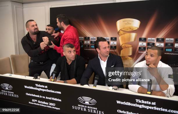 Boxing promoter Ahmet Oner gestures towards one of Eubank's staff and is held back by members of his team, at a press conference ahead of the World...