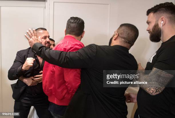 Boxing promoter Ahmet Oner wants to go for one of Eubank's staff and is held back, at a press conference ahead of the World Boxing Super Series...