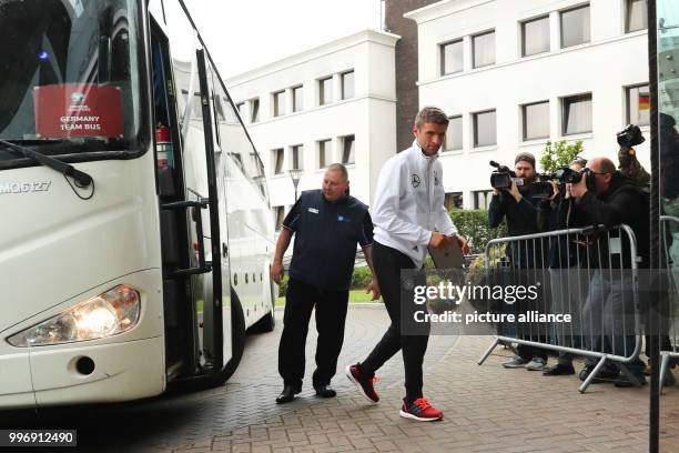 Germany's Thomas Mueller gets out of the bus and goes to the team hotel ahead of the World Cup qualifier football match between Northern Ireland and...