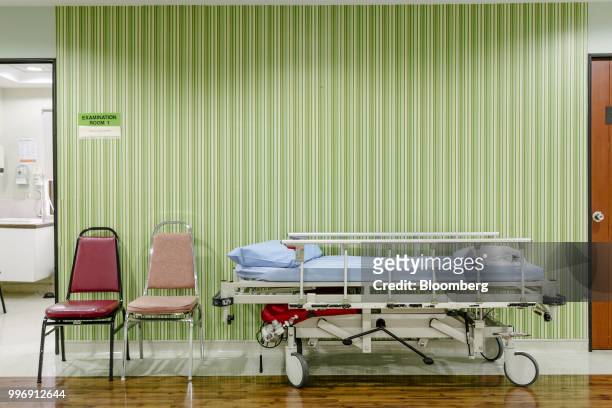 Hospital bed and chairs sits in a corridor at the Tun Hussein Onn National Eye Hospital in Petaling Jaya, Selangor, Malaysia, on Tuesday, July 10,...