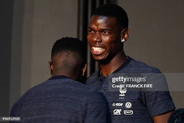 France's defender Samuel Umtiti jokes with midfielder Paul Pogba before a press conference at the press centre in Istra, west of Moscow, on July 12...